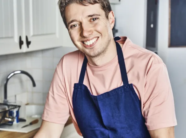 ean Covillault in the kitchen, presenting a veal chop grilled on a wooden plan